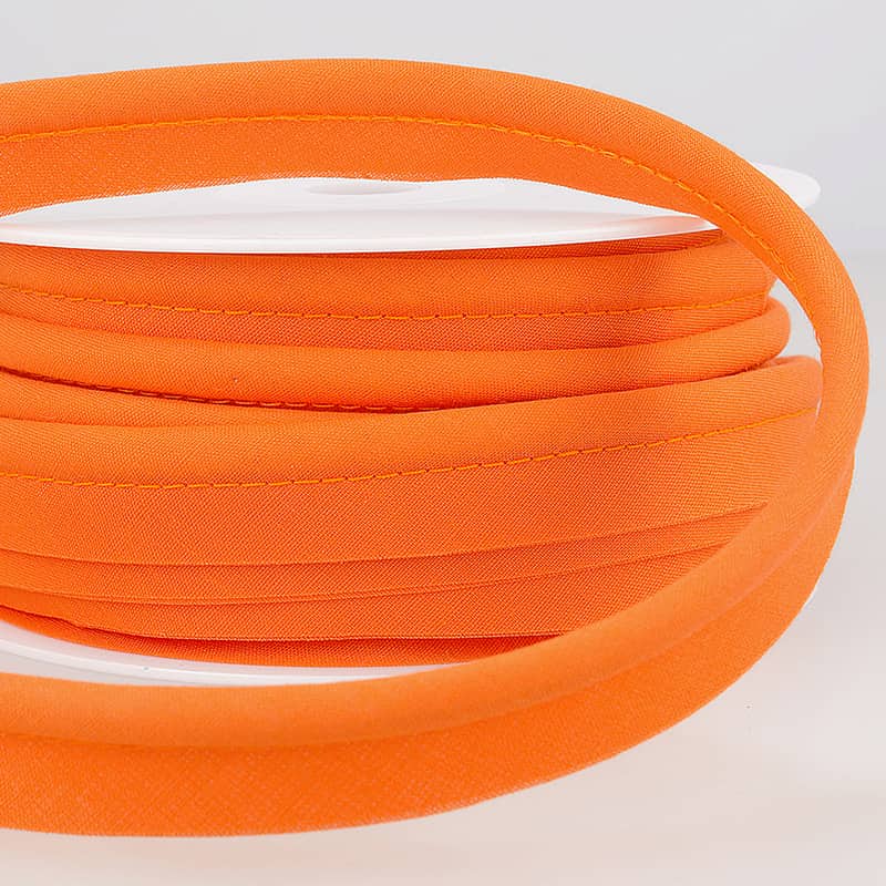 A roll of coloured piping on a white table.