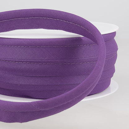 Purple piping on a white spool against a light gray background
