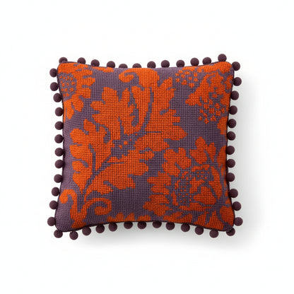 venetian pattern tapestry kit made into a cushion with antique purple pom pom trim.