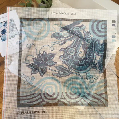 Blue dragon design on canvas for cross stitch.