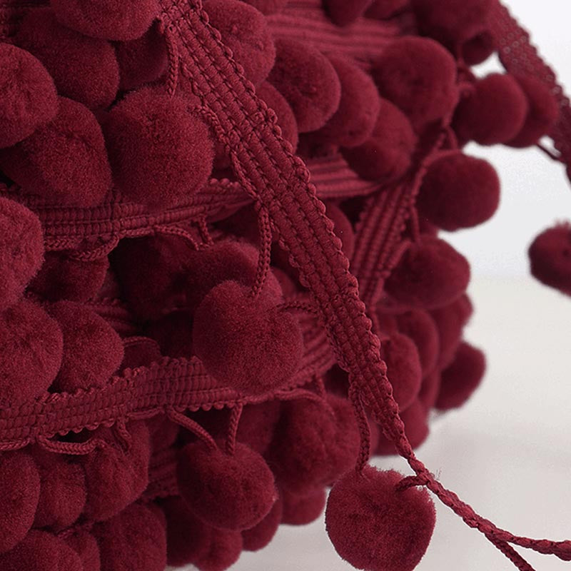 Burgunday and raspberry pom poms 15mm close up.