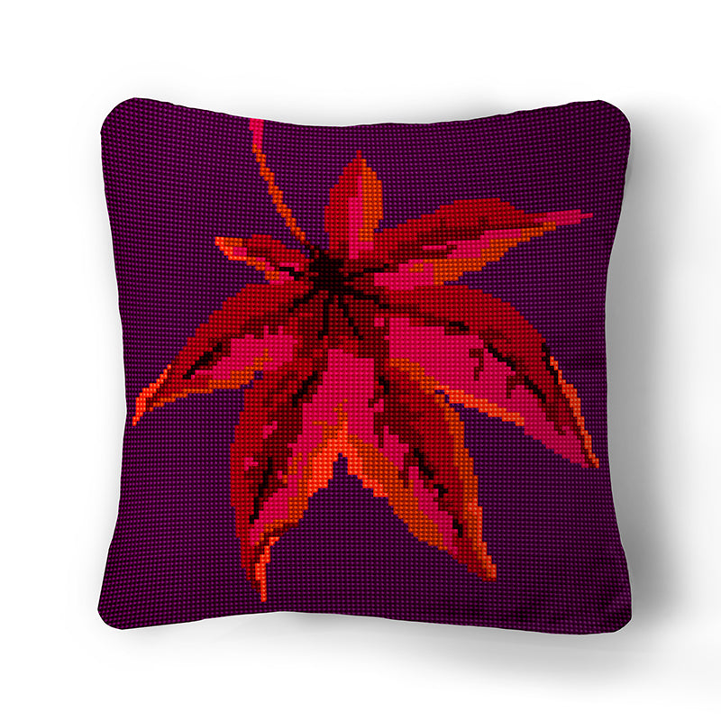 Autumn Leaf Tapestry Kit made up into a cushion. Size is 12 inches square and the colours are russets, pinks and oranges on a purple background.