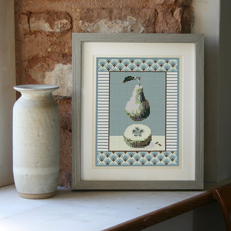 Pear and pips on soft blue, on window sill with pot.